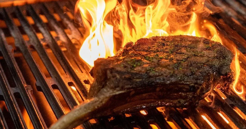 Tomahawk steak over open flame at THE RANCH